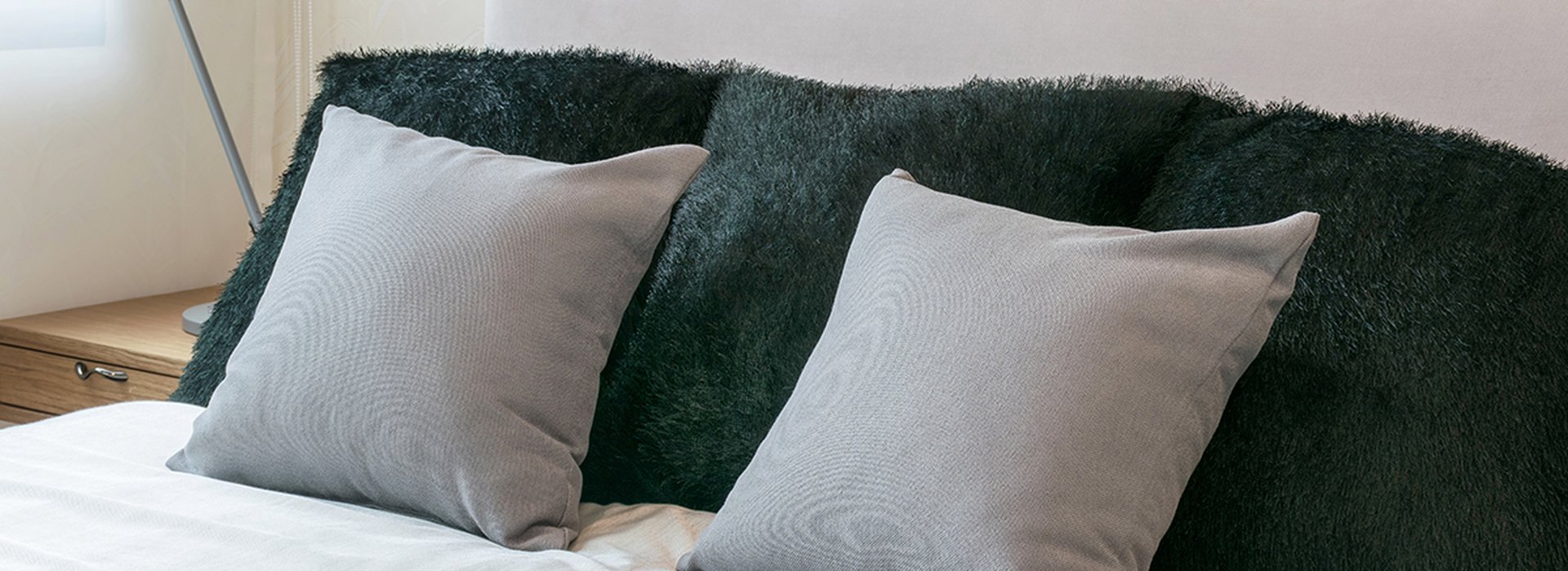 bedroom-interior-design-with-grey-pillows-on-white-bed-